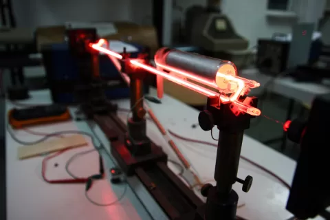 Optically clear adhesive systems for laser applications